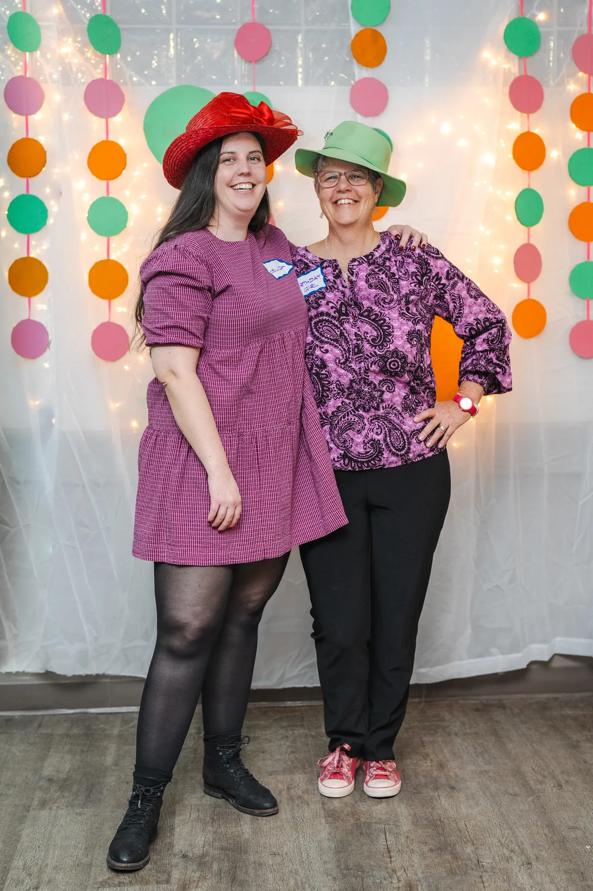 Guests posing in playful hats at Alison’s birthday celebration.