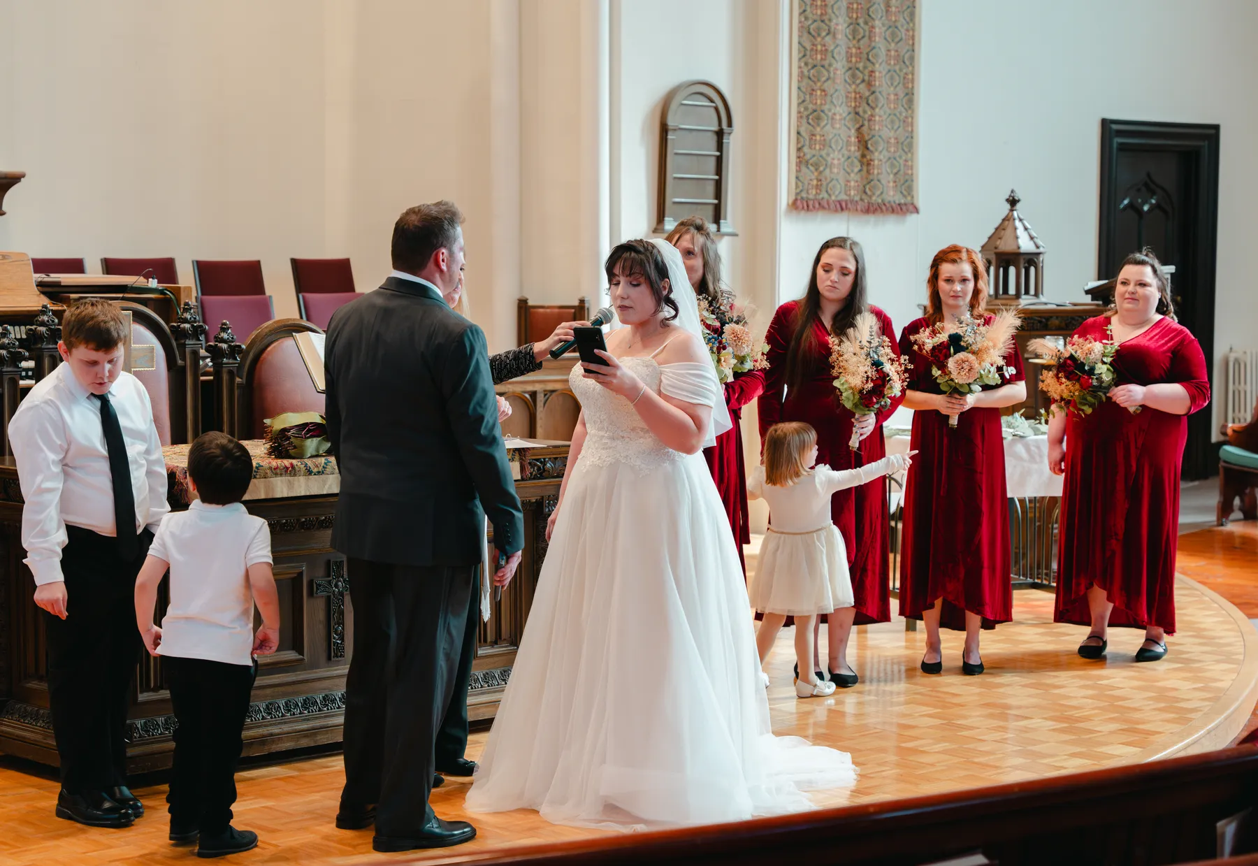 The couple and wedding party during the church ceremony at Kody and Jaz’s wedding.