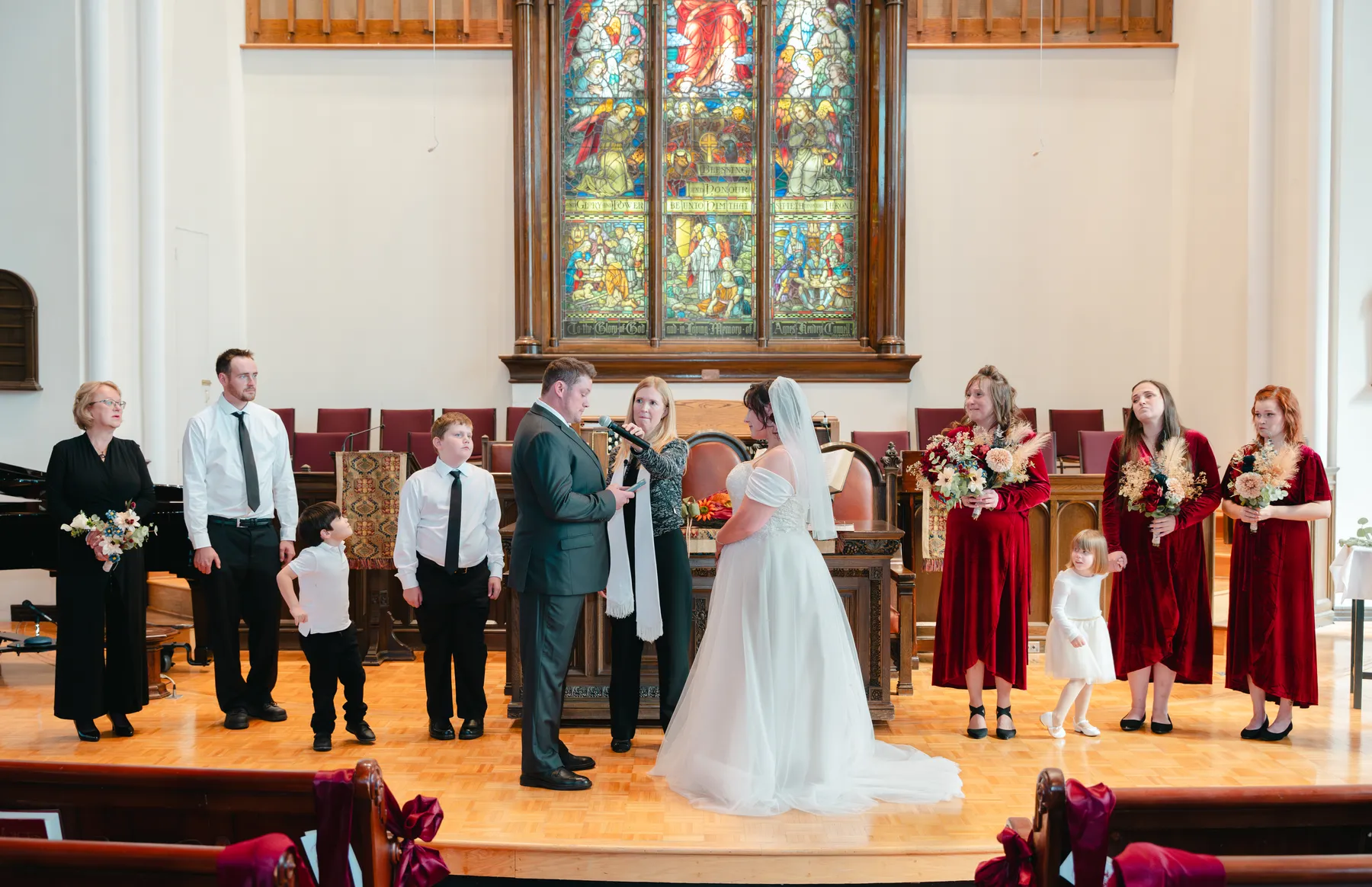 The couple and wedding party during the church ceremony at Kody and Jaz’s wedding.