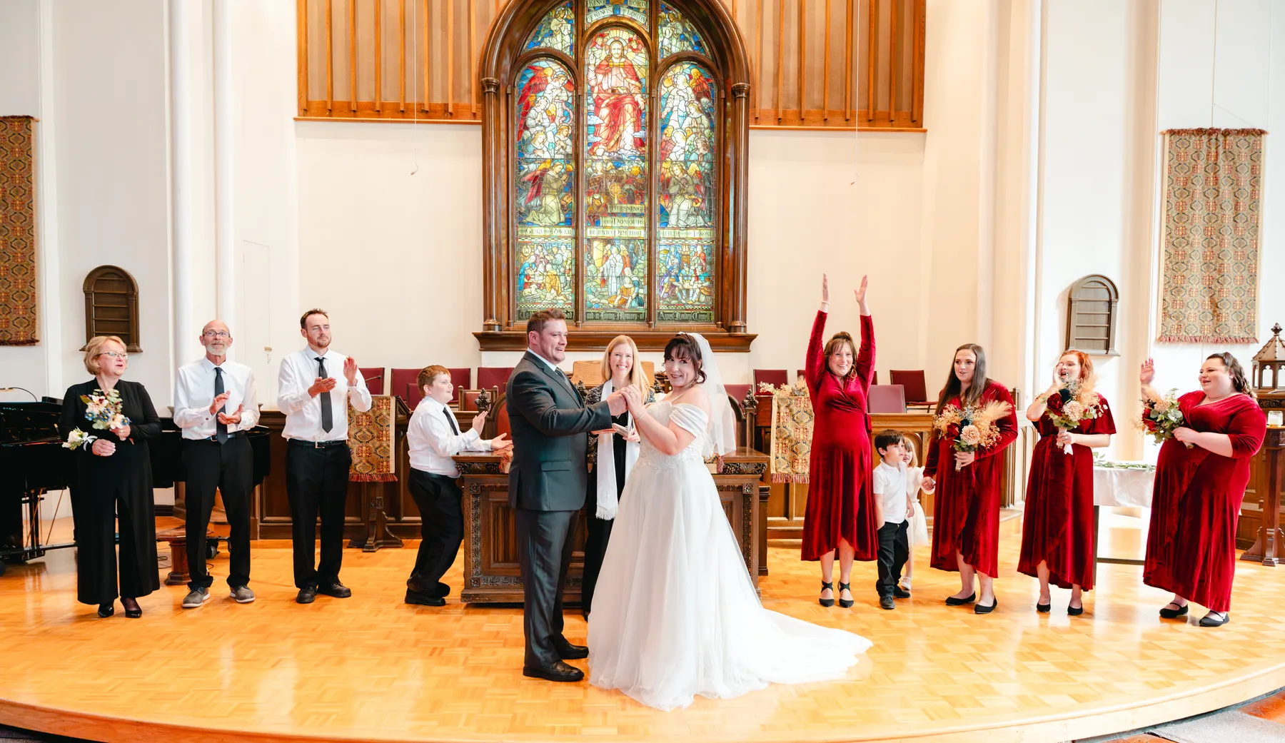 The couple walking down the church aisle after the ceremony at Kody and Jaz’s wedding.