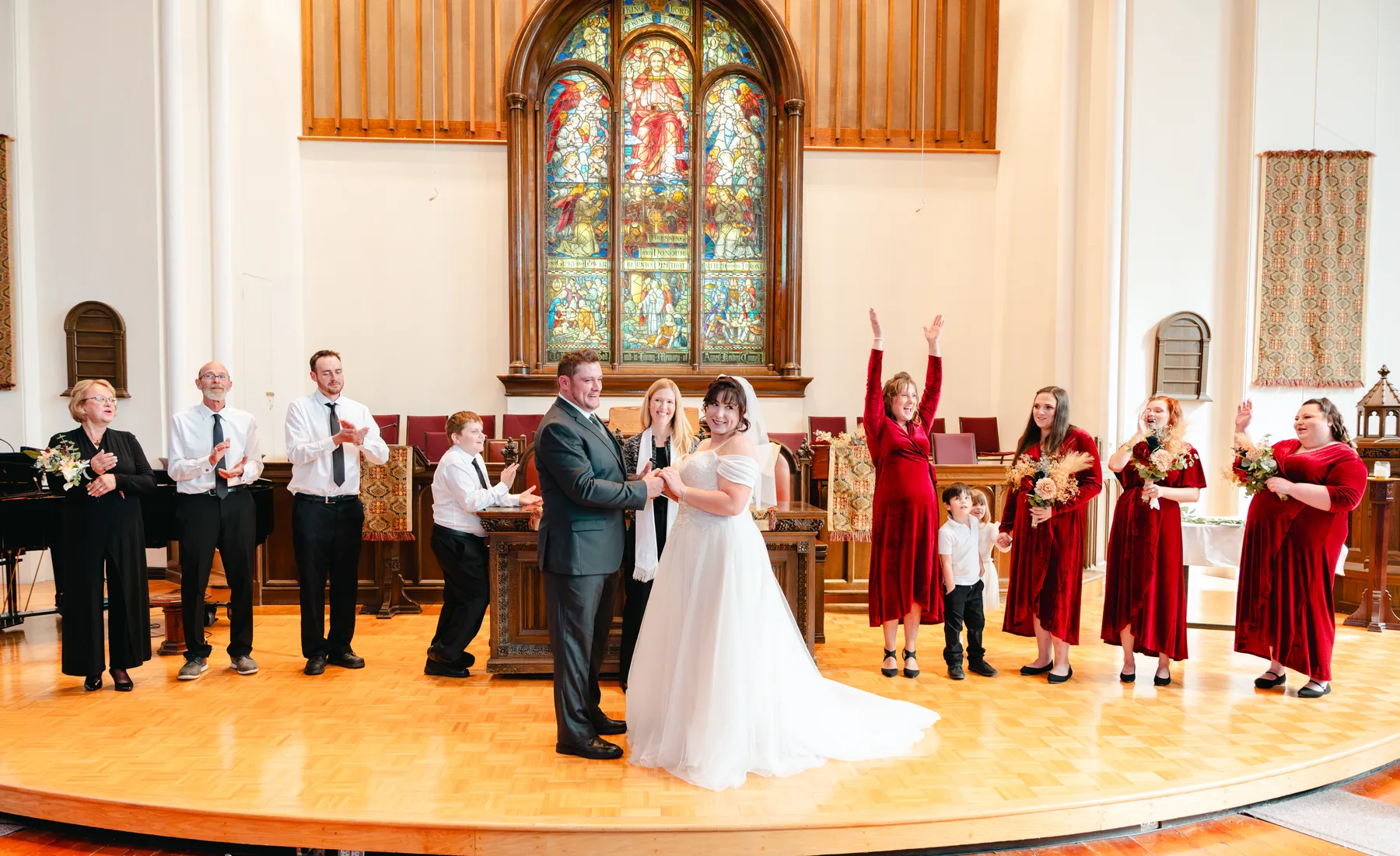 The couple walking down the church aisle after the ceremony at Kody and Jaz’s wedding.