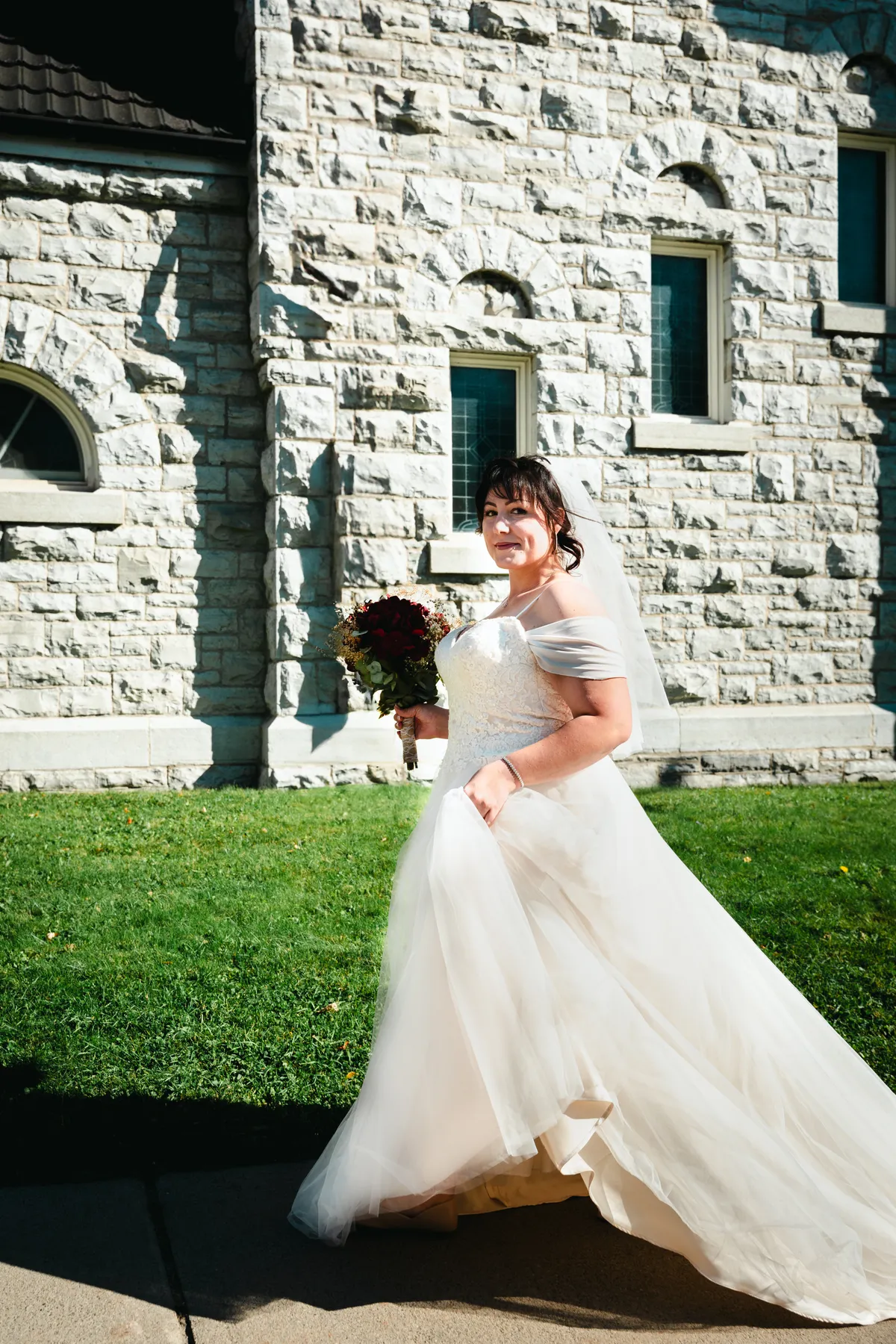 The bride posing beside the church at Kody and Jaz’s wedding.
