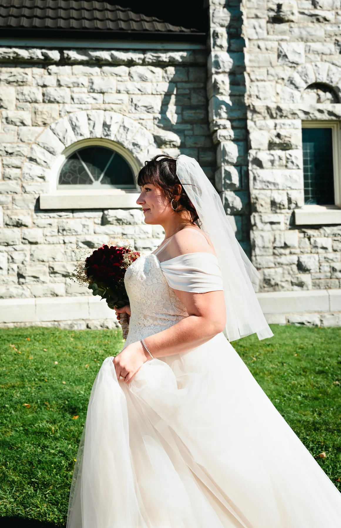 The bride posing beside the church at Kody and Jaz’s wedding.