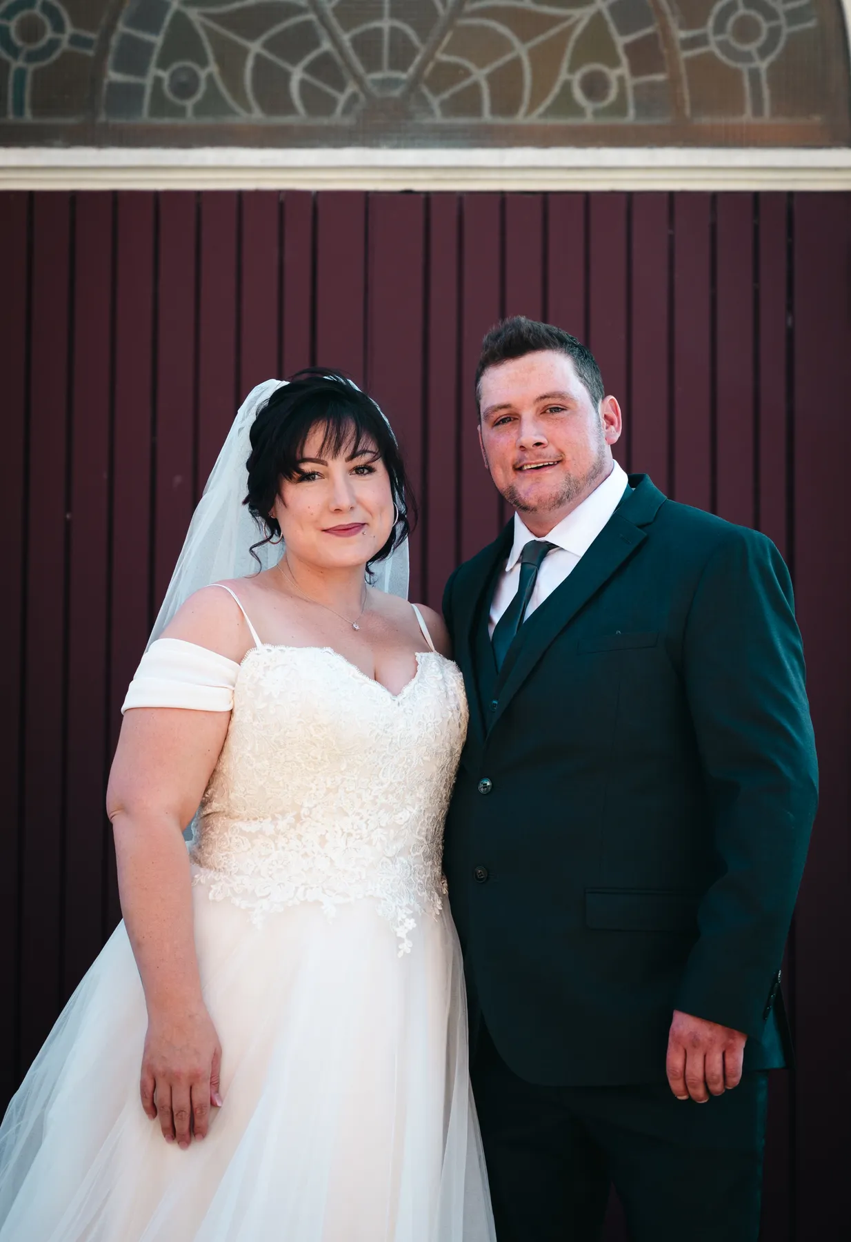 The couple embracing at the church door at Kody and Jaz’s wedding.