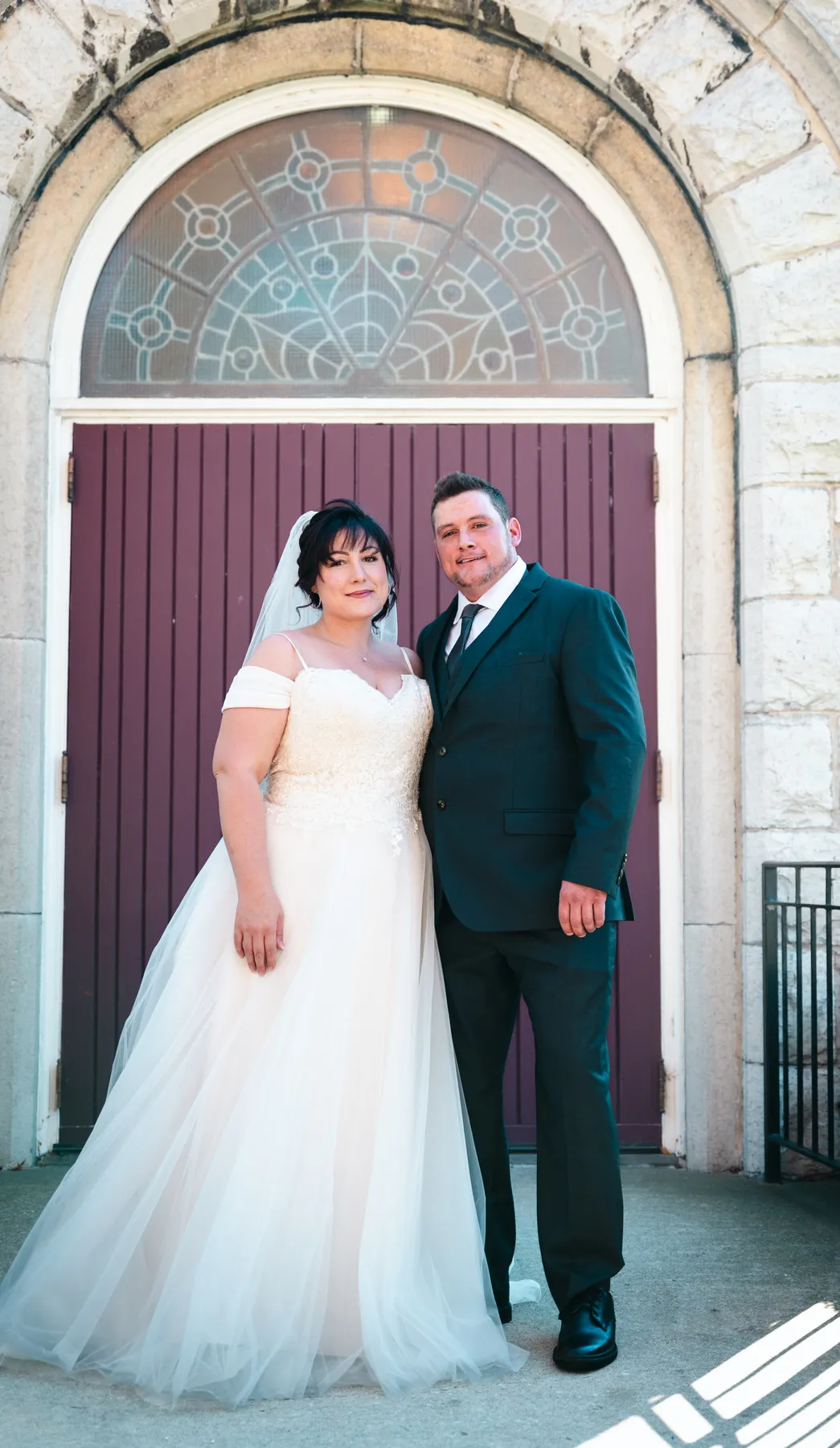 The couple embracing at the church door at Kody and Jaz’s wedding.