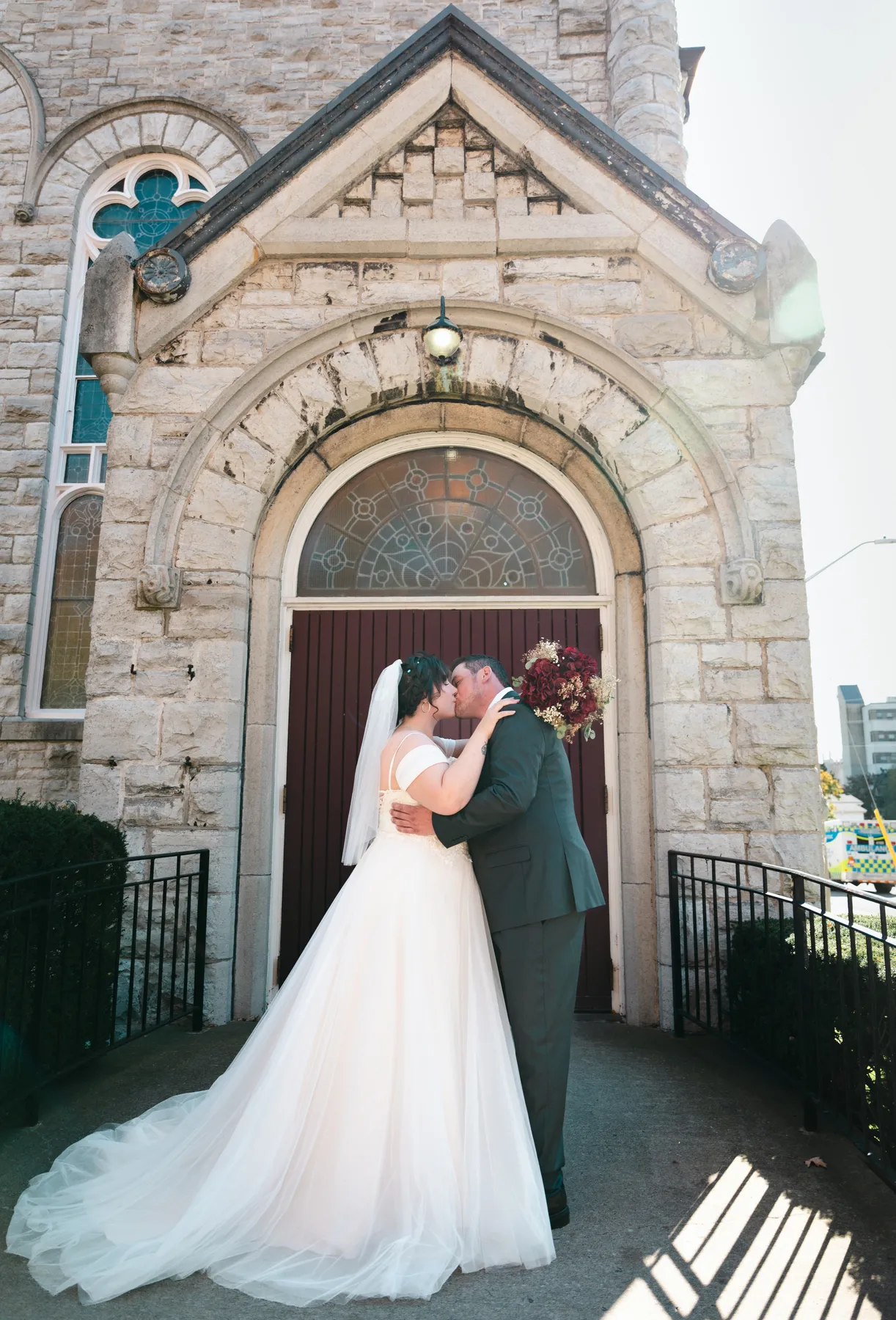 The couple embracing at the church door at Kody and Jaz’s wedding.