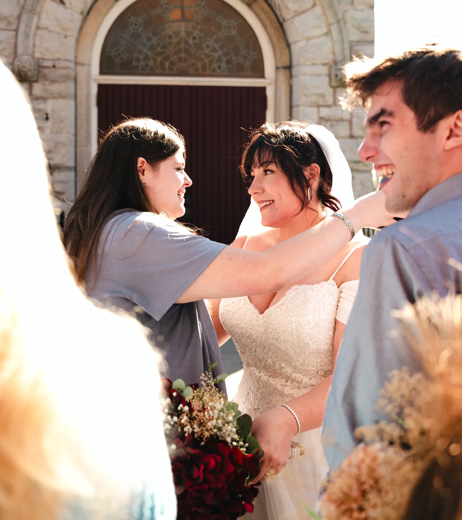 The bride greeting guests outdoors at Kody and Jaz’s wedding.