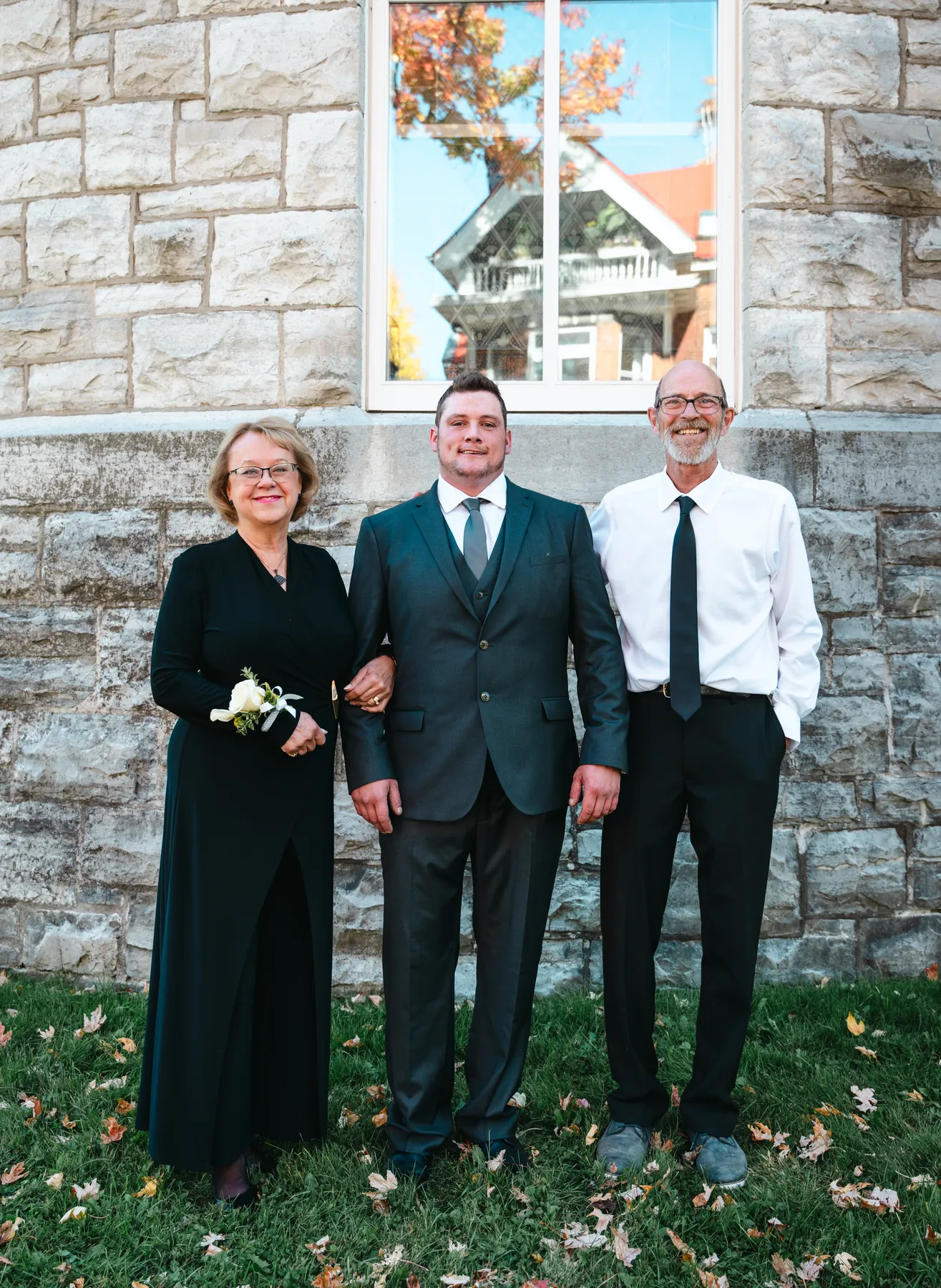 The groom posing with male guests outside the church at Kody and Jaz’s wedding.