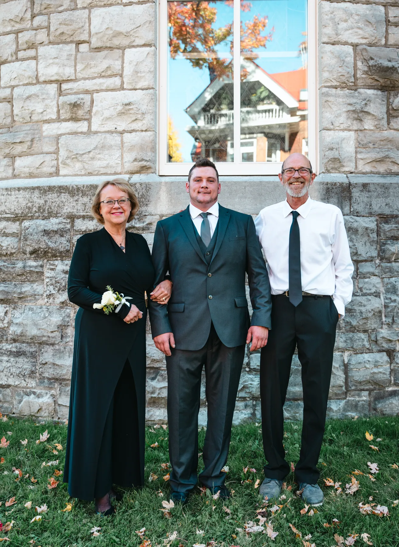 The groom posing with male guests outside the church at Kody and Jaz’s wedding.