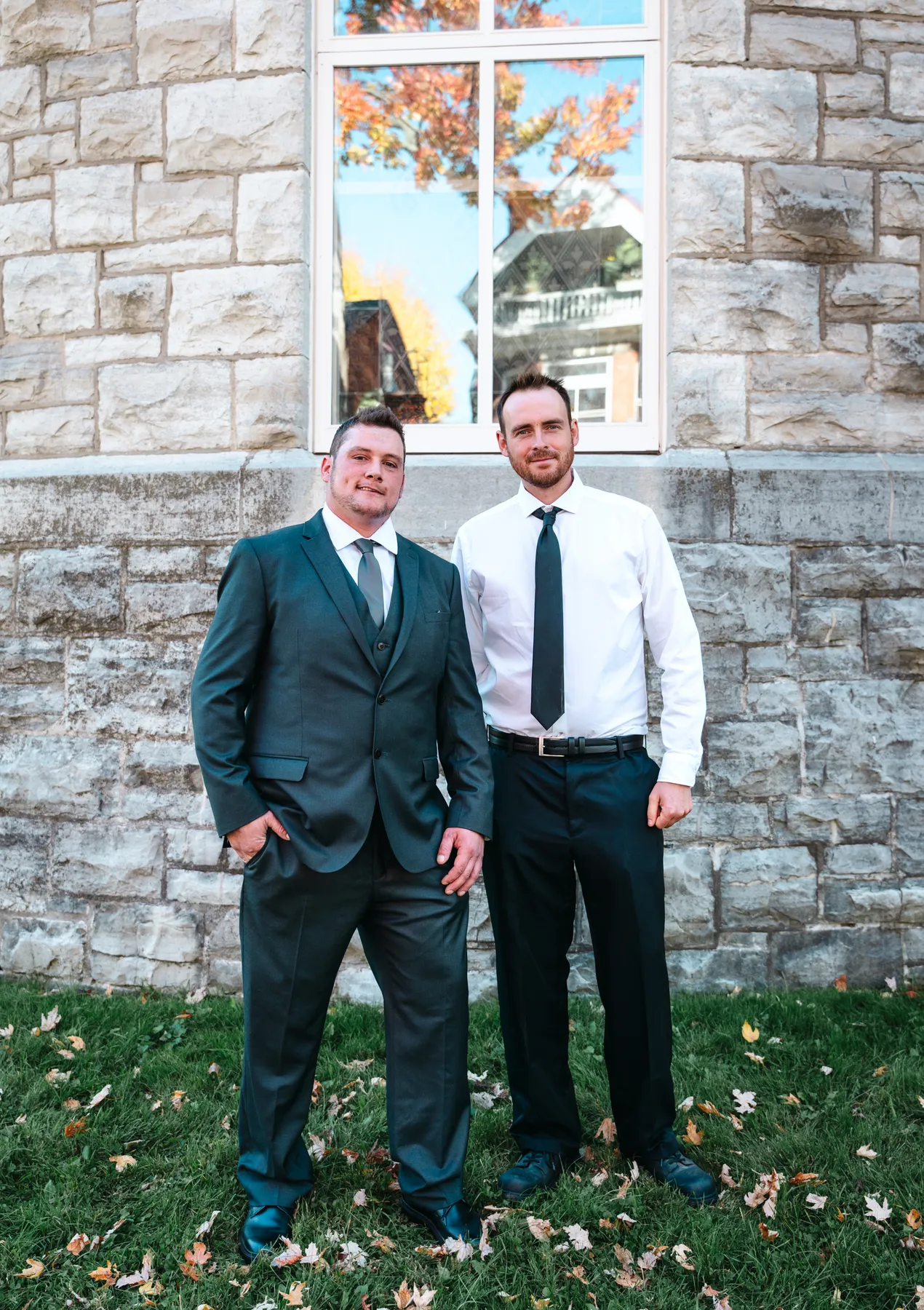 The groom posing with male guests outside the church at Kody and Jaz’s wedding.