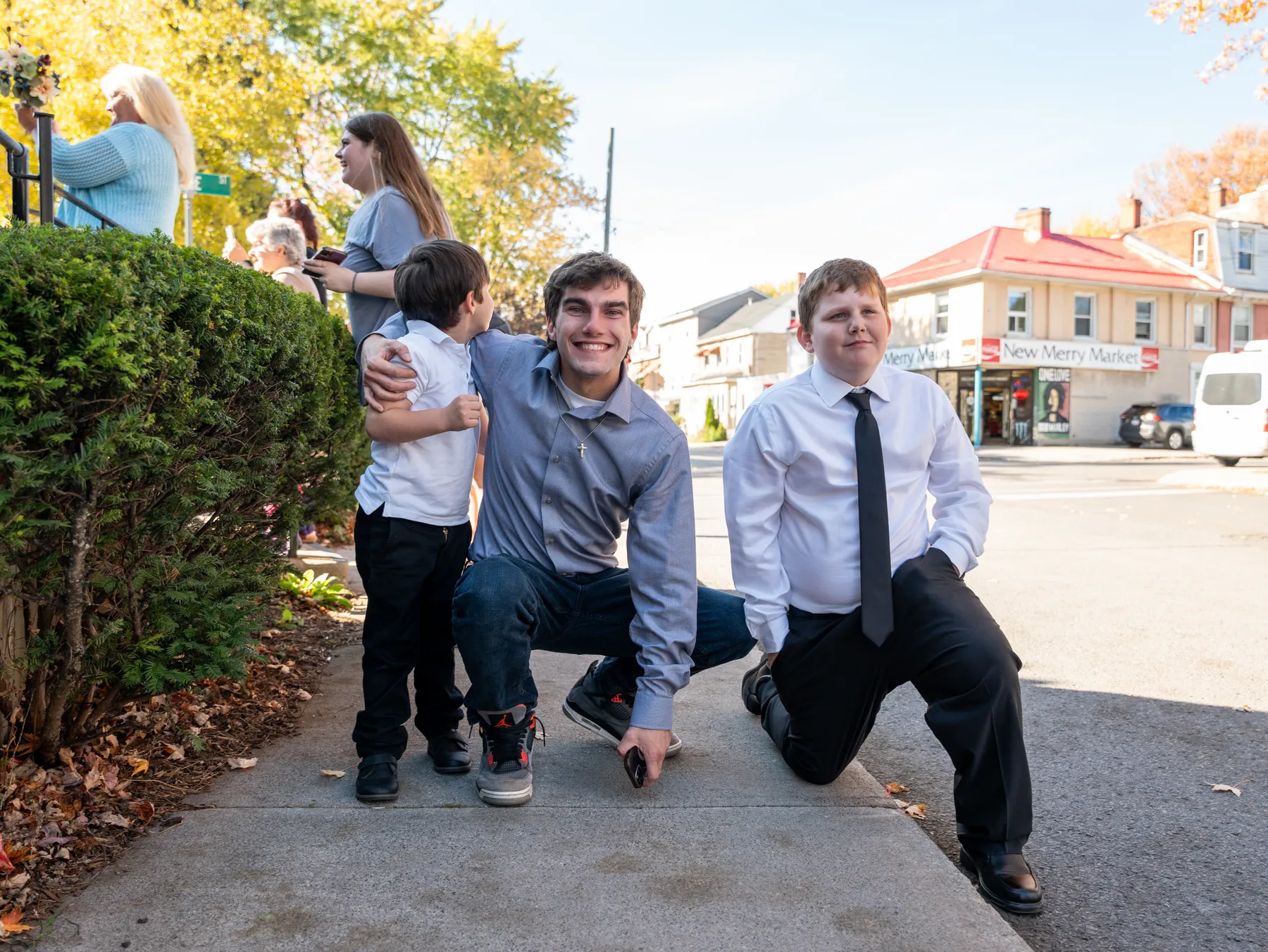 Groomsmen striking playful poses outdoors at Kody and Jaz’s wedding.