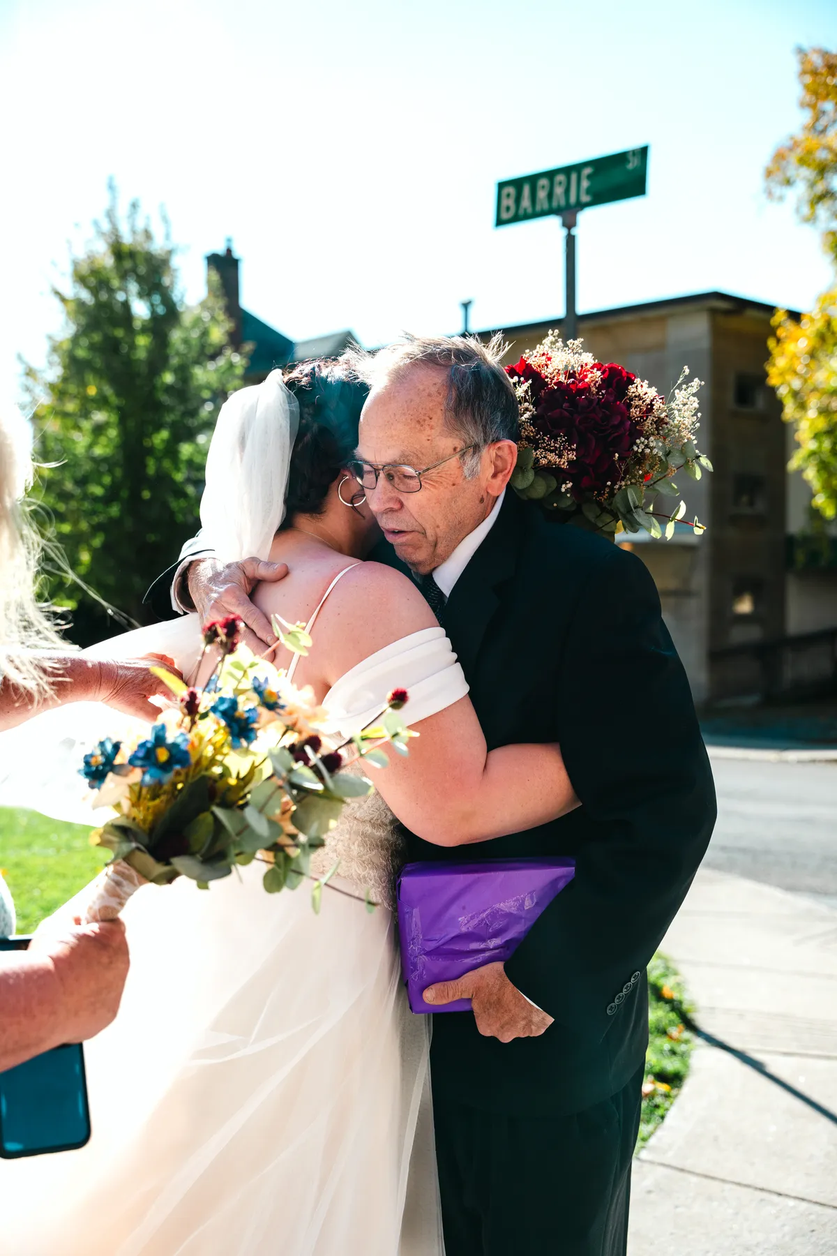 The bride with guests outdoors at Kody and Jaz’s wedding.
