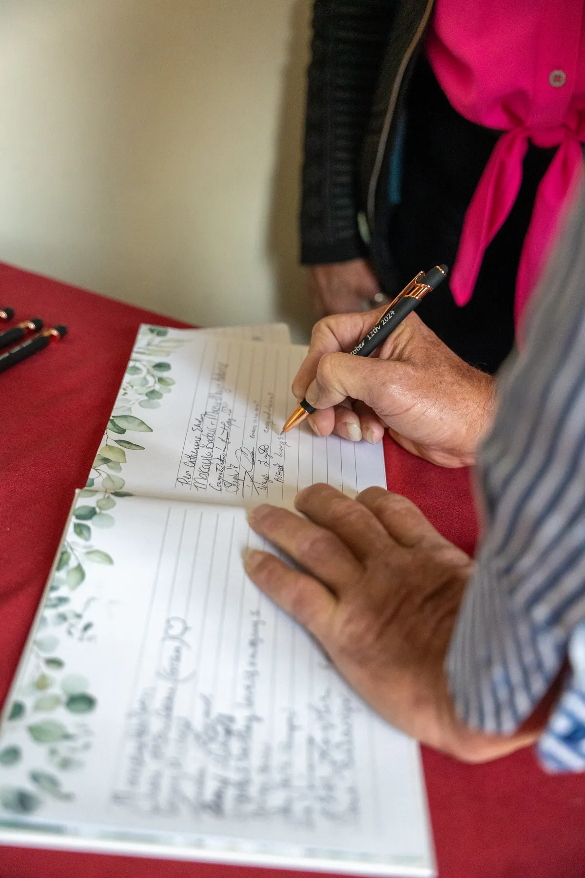 Guests signing the guest book at Kody and Jaz’s wedding.