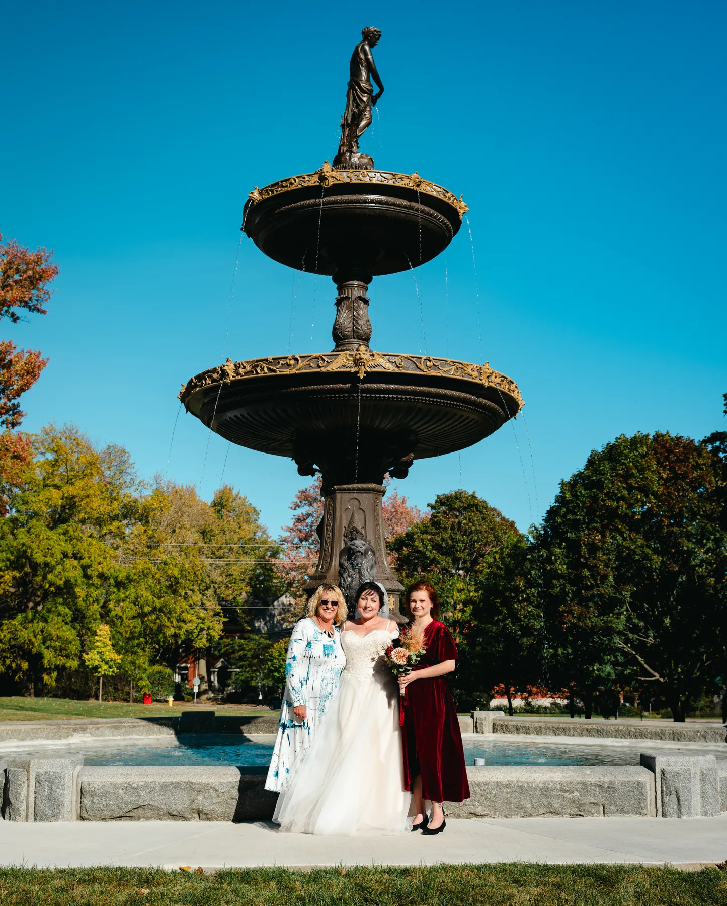 The couple posing by a large fountain at Kody and Jaz’s wedding.