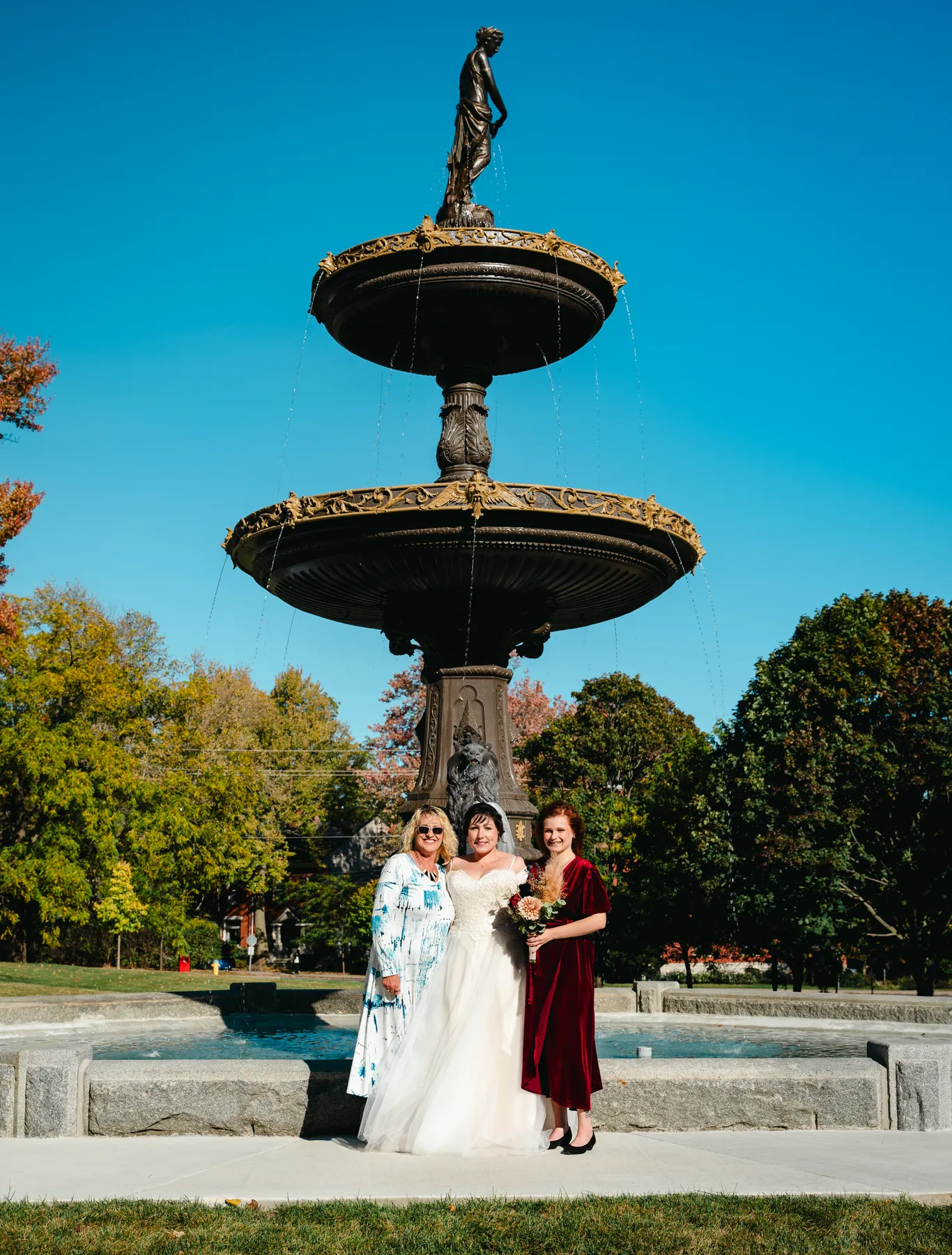 The couple posing by a large fountain at Kody and Jaz’s wedding.