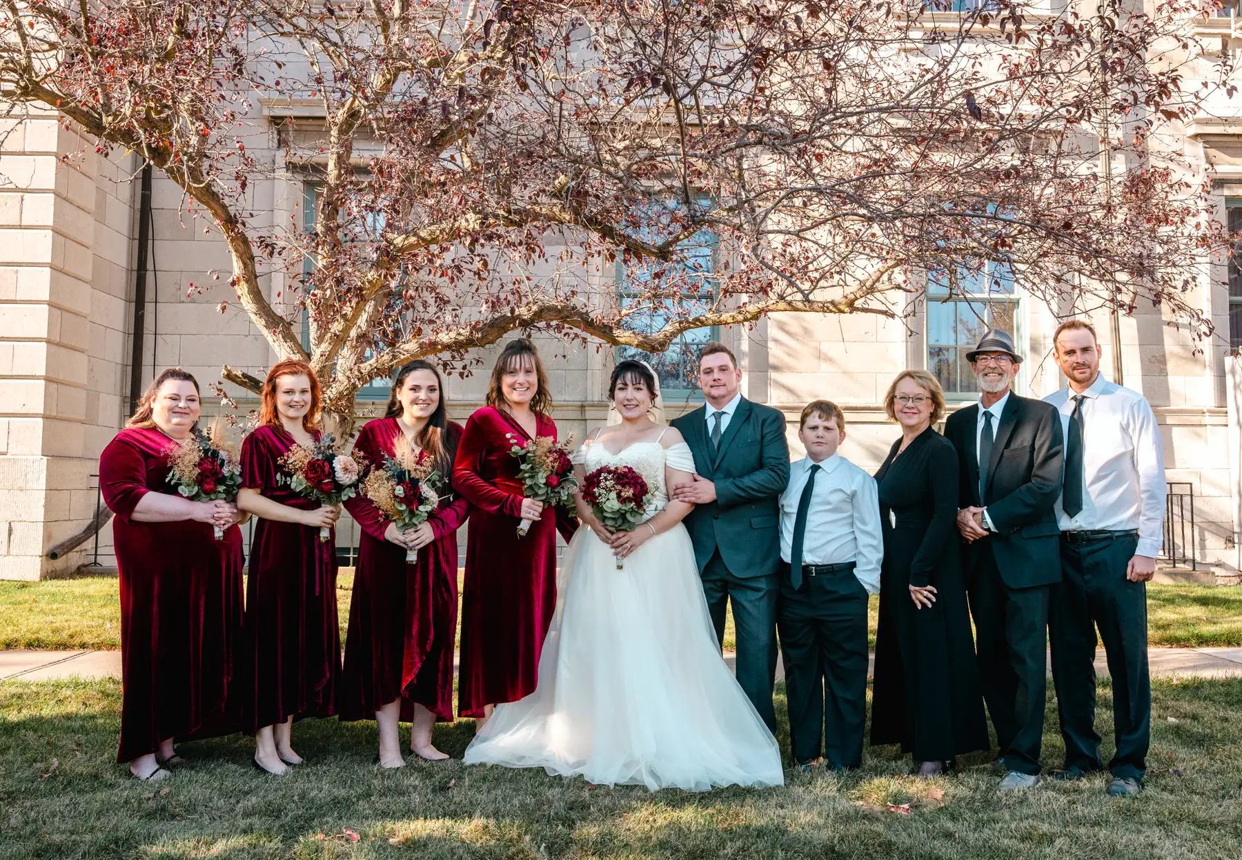 The wedding party posing outdoors at Kody and Jaz’s wedding.