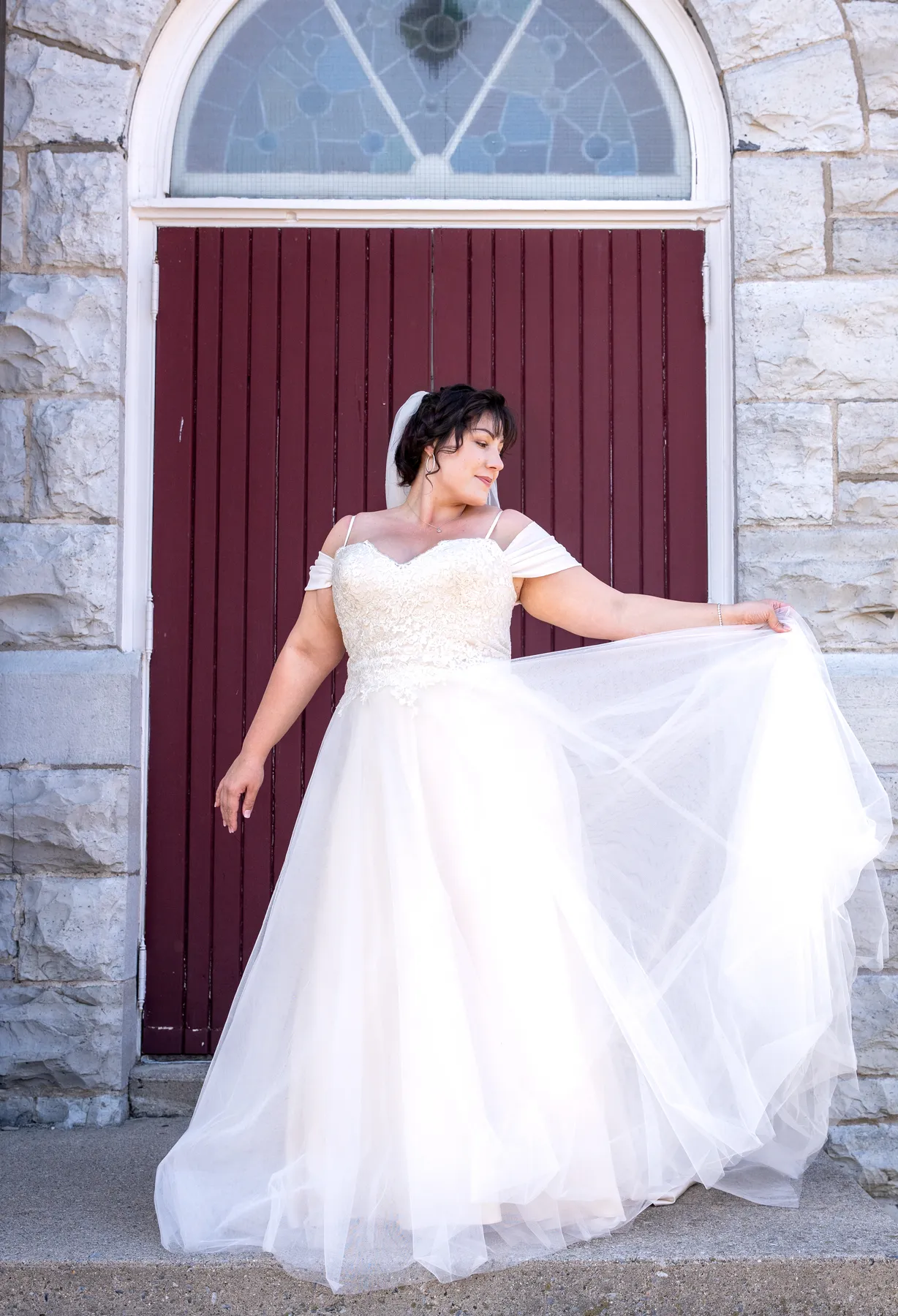 The bride posing outside the church at Kody and Jaz’s wedding.