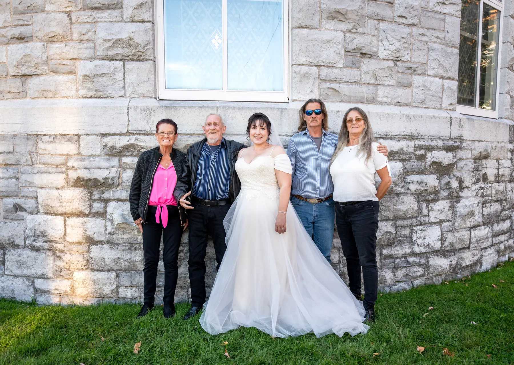 The bride with guests outside the church at Kody and Jaz’s wedding.