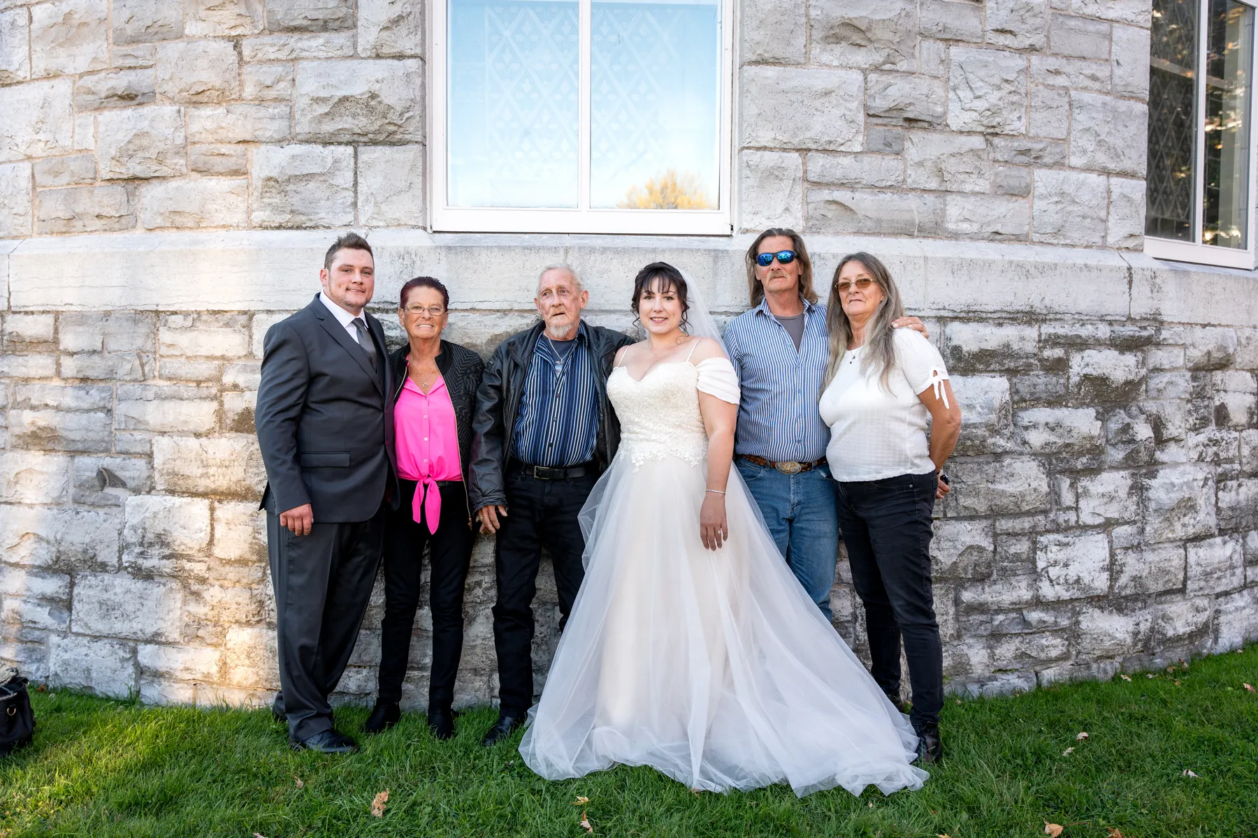 The bride with guests outside the church at Kody and Jaz’s wedding.