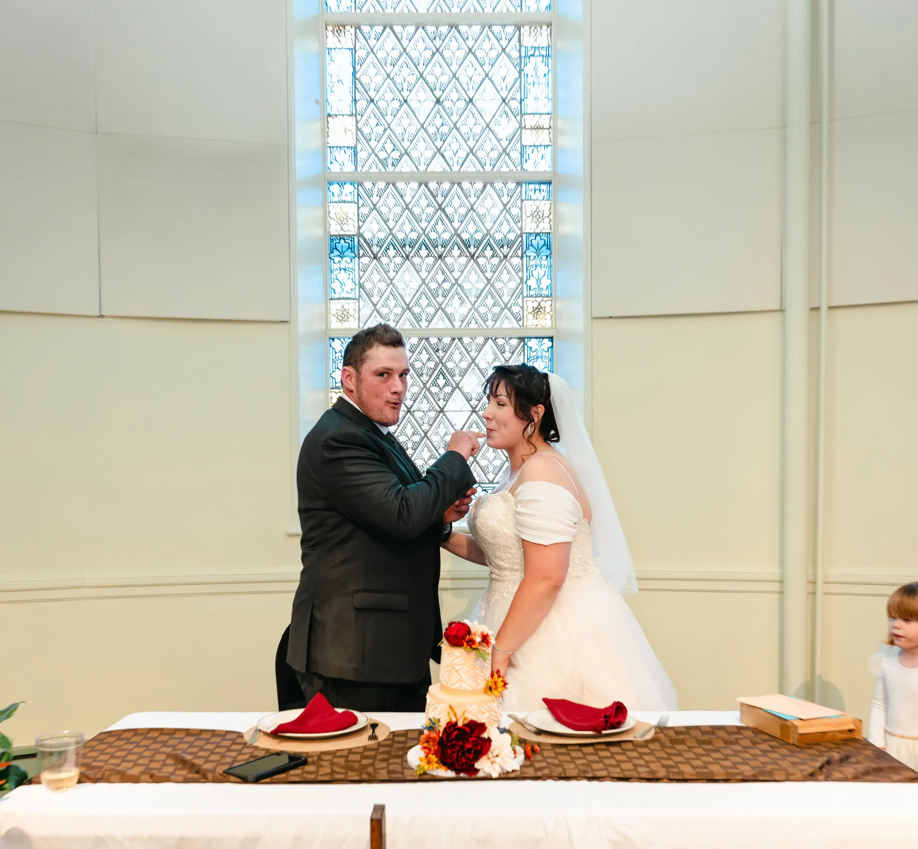 The couple feeding each other wedding cake at Kody and Jaz’s wedding.