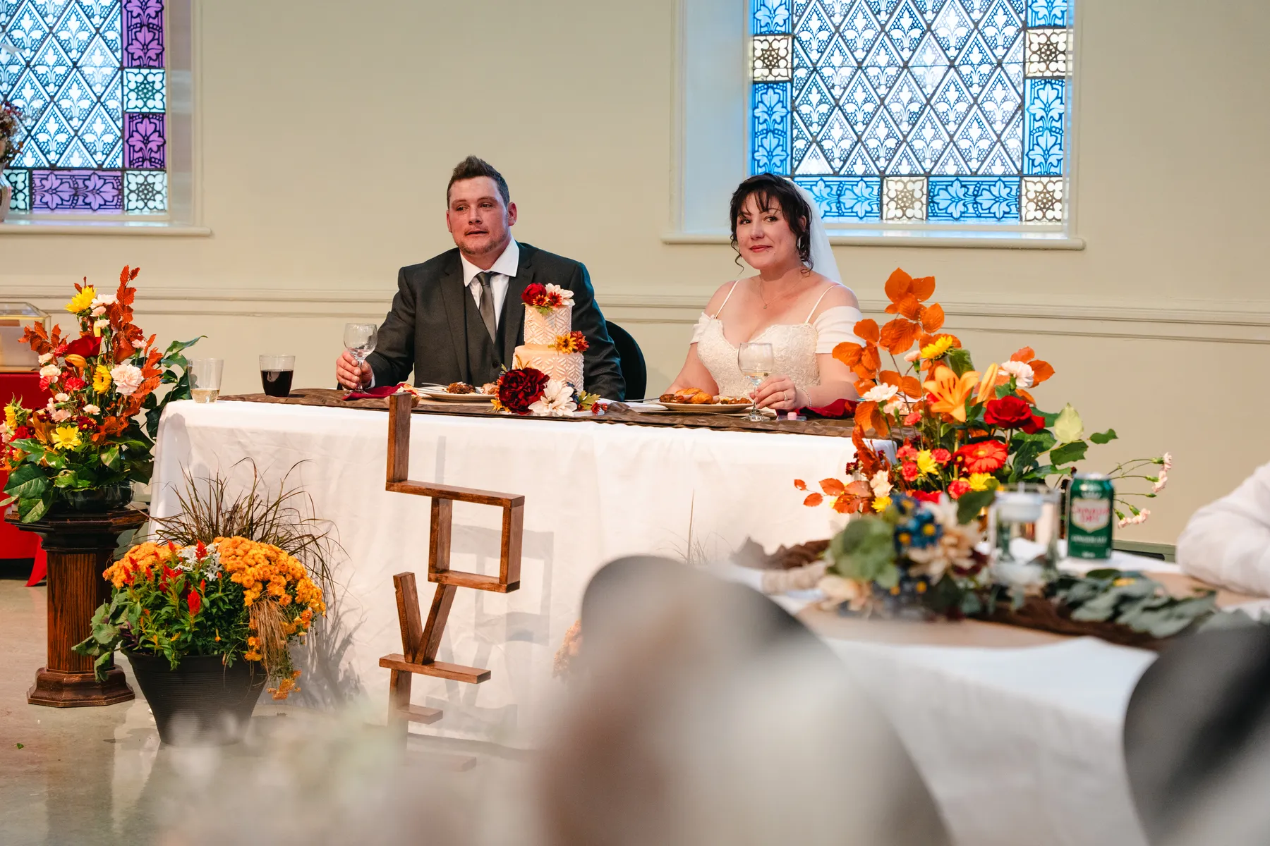The couple at the head table during speeches at Kody and Jaz’s wedding.