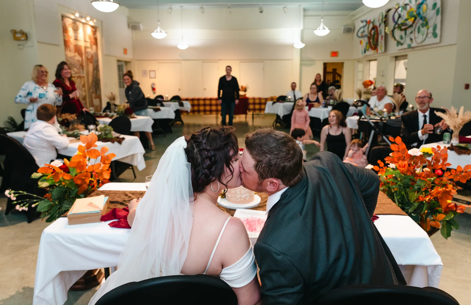 The couple at the head table during speeches at Kody and Jaz’s wedding.