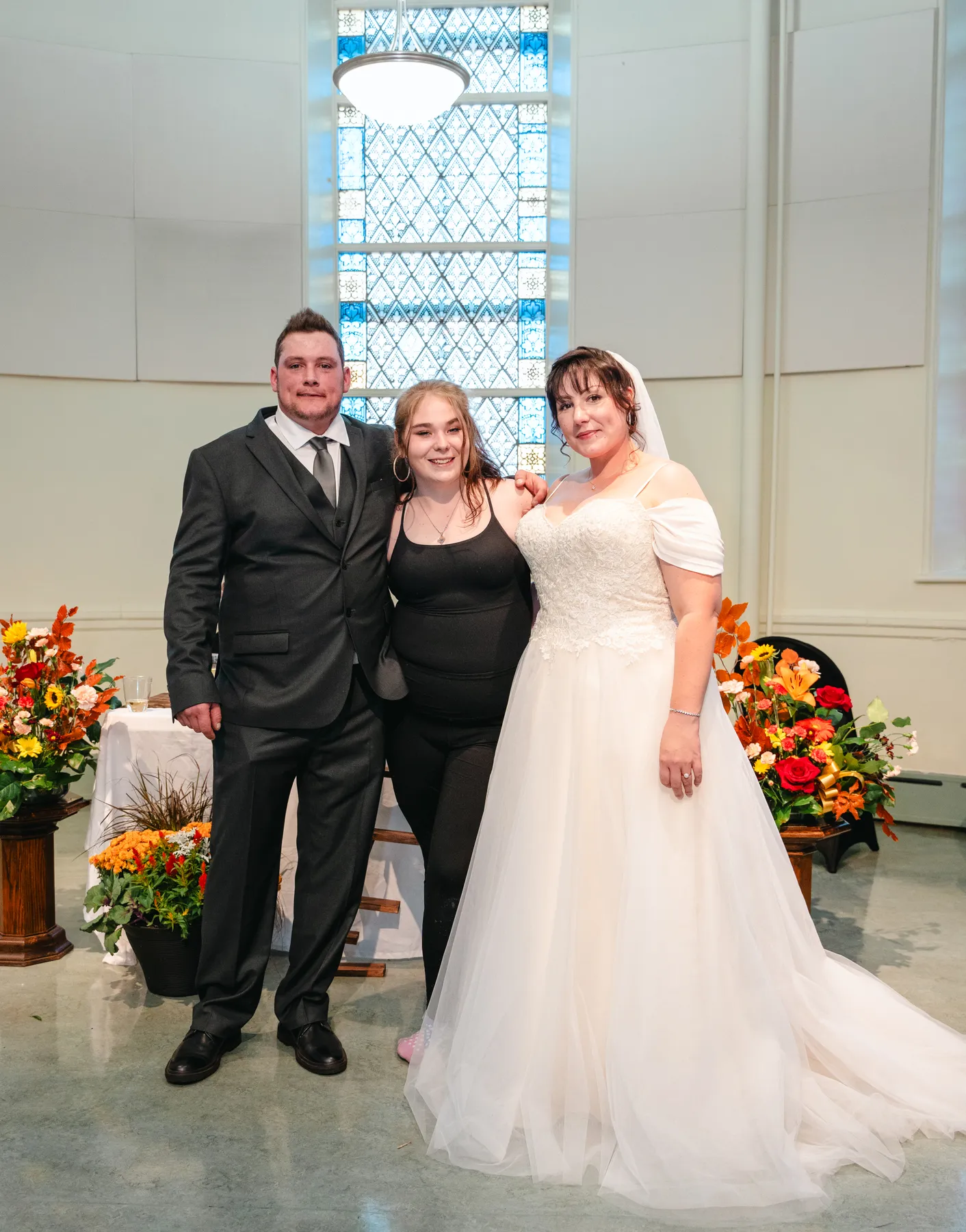 The couple with guests at the reception at Kody and Jaz’s wedding.