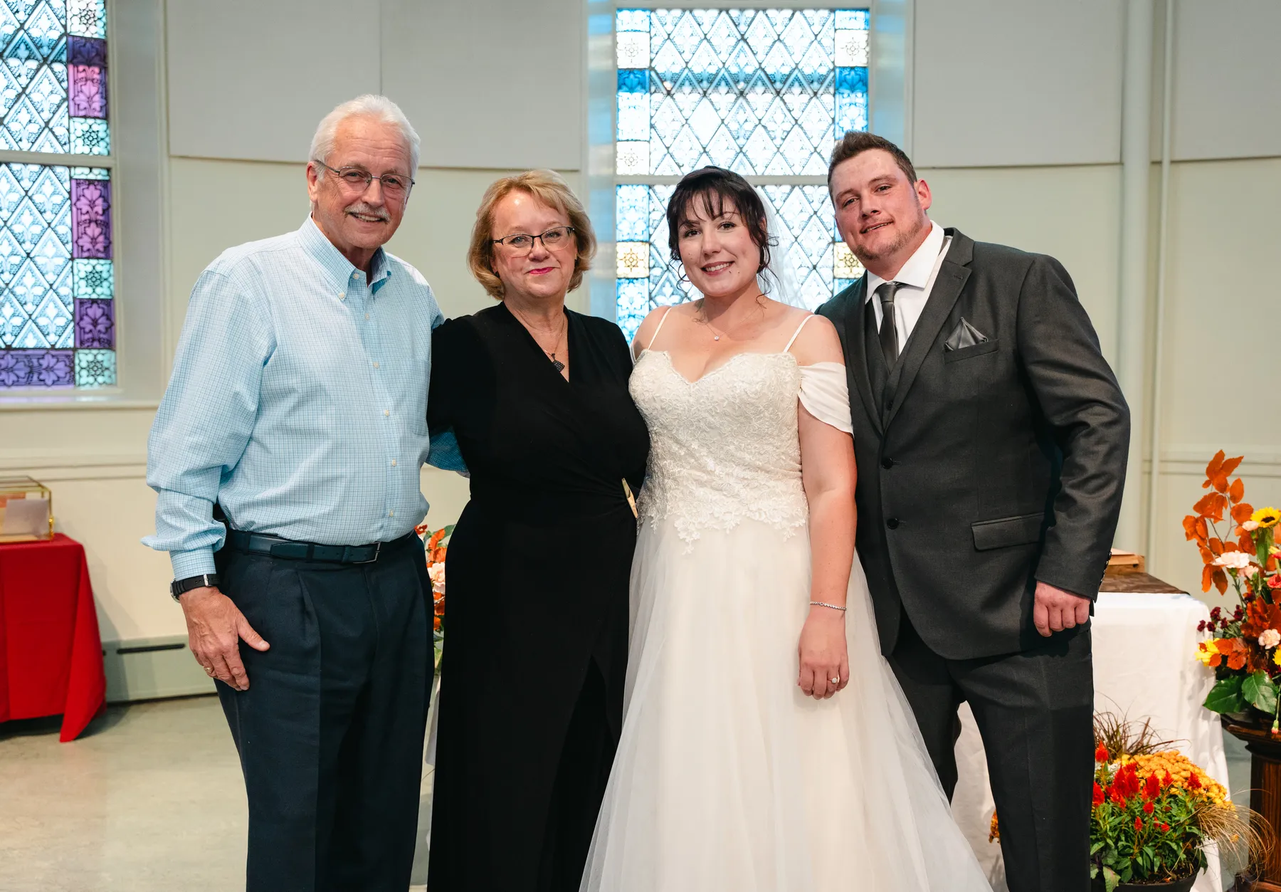 The couple with guests at the reception at Kody and Jaz’s wedding.