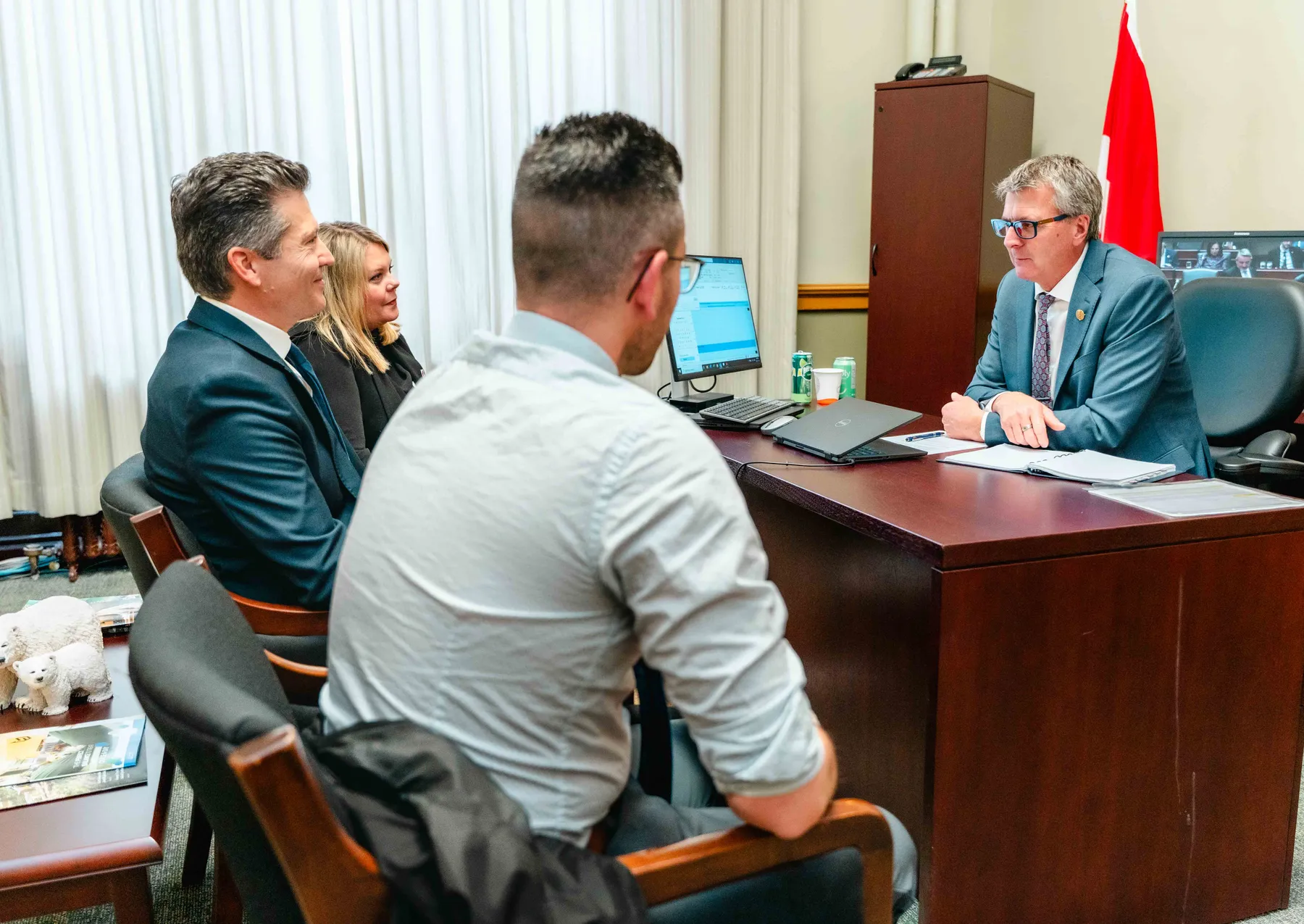 Participants meeting and talking in an office at the IBAO event at Queen’s Park.