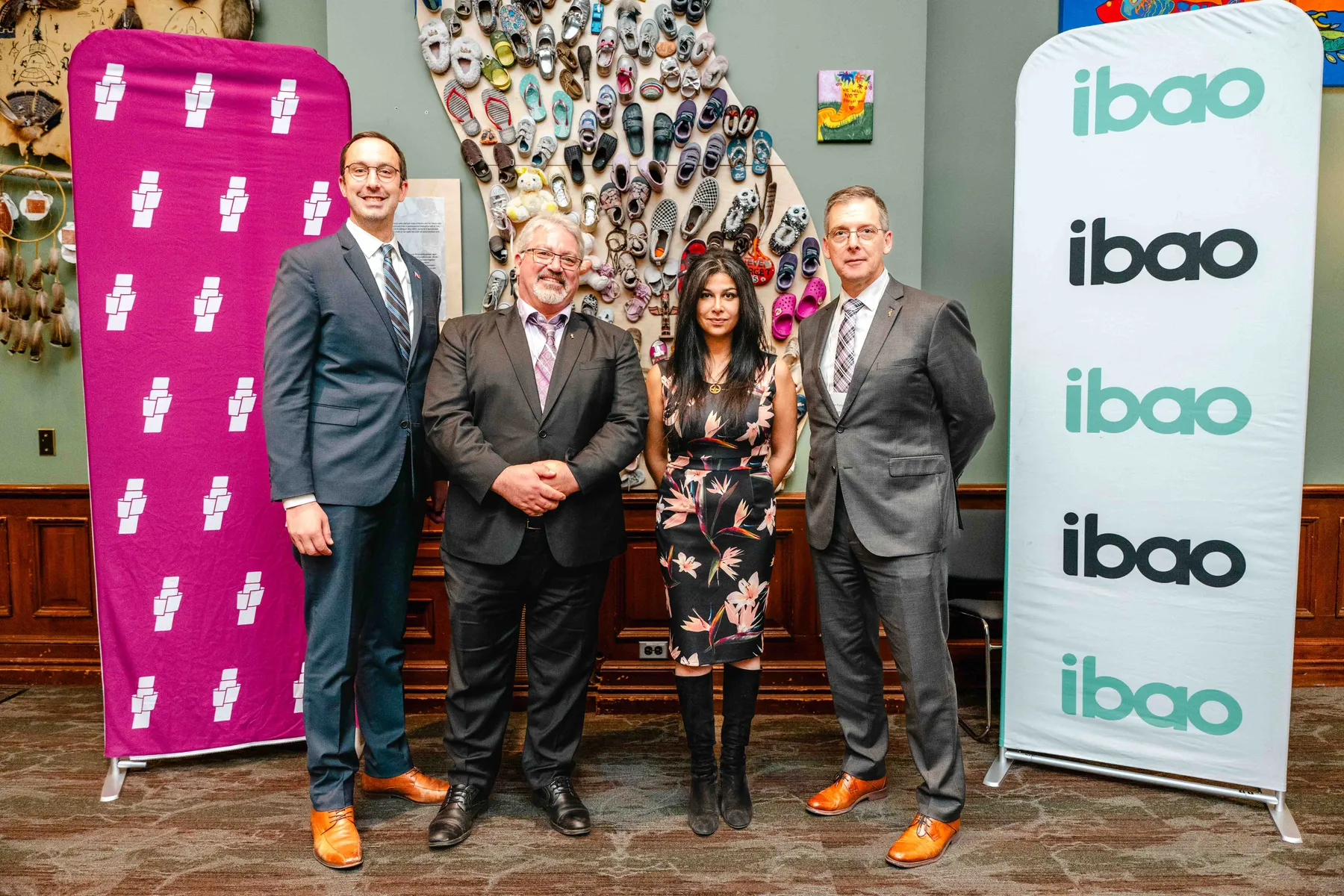 Participants posing beside an IBAO display at the IBAO event at Queen’s Park.