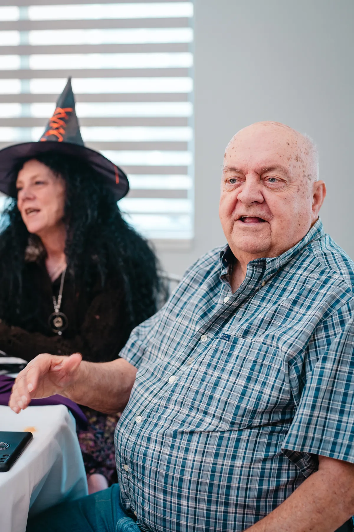 Guests chatting at party tables at Jenna and Jake’s Halloween party.