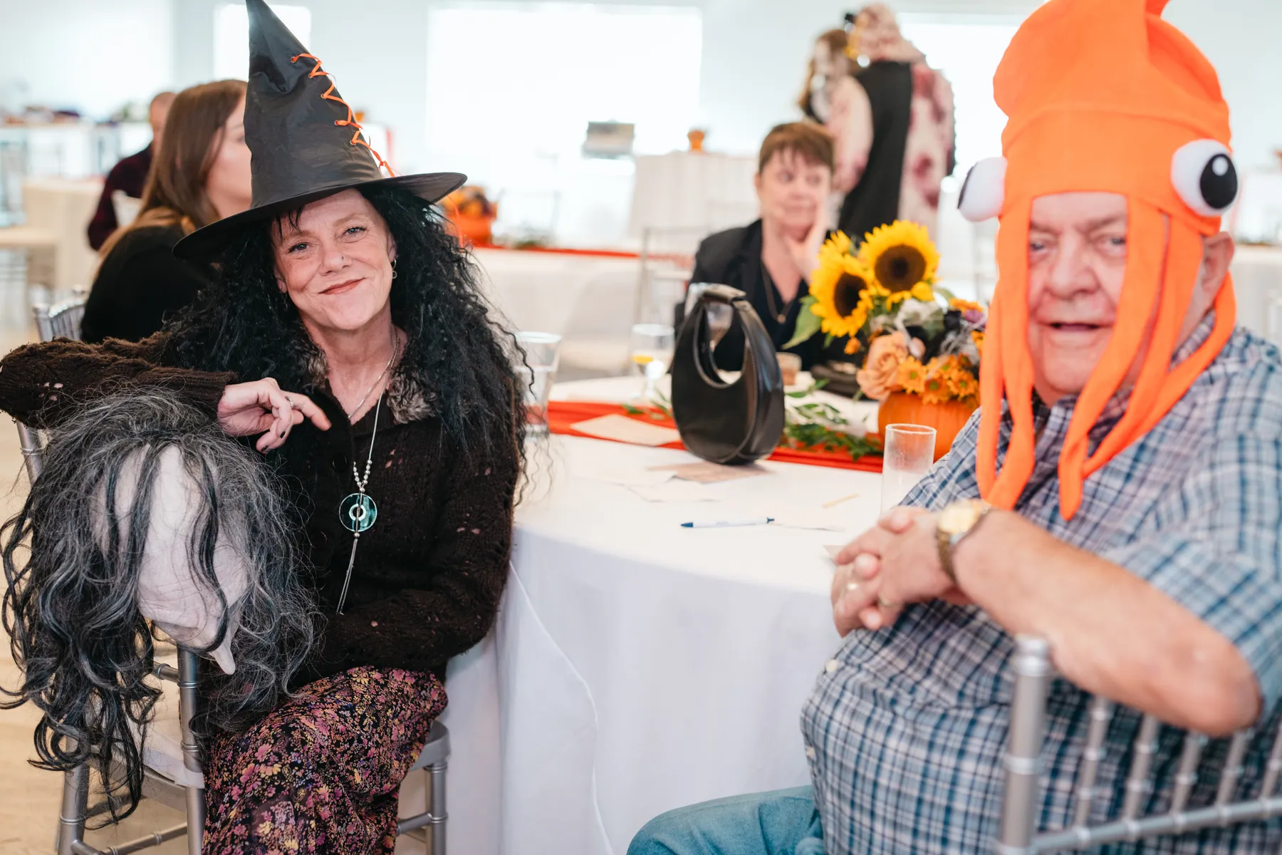 Costumed guests posing together indoors at Jenna and Jake’s Halloween party.