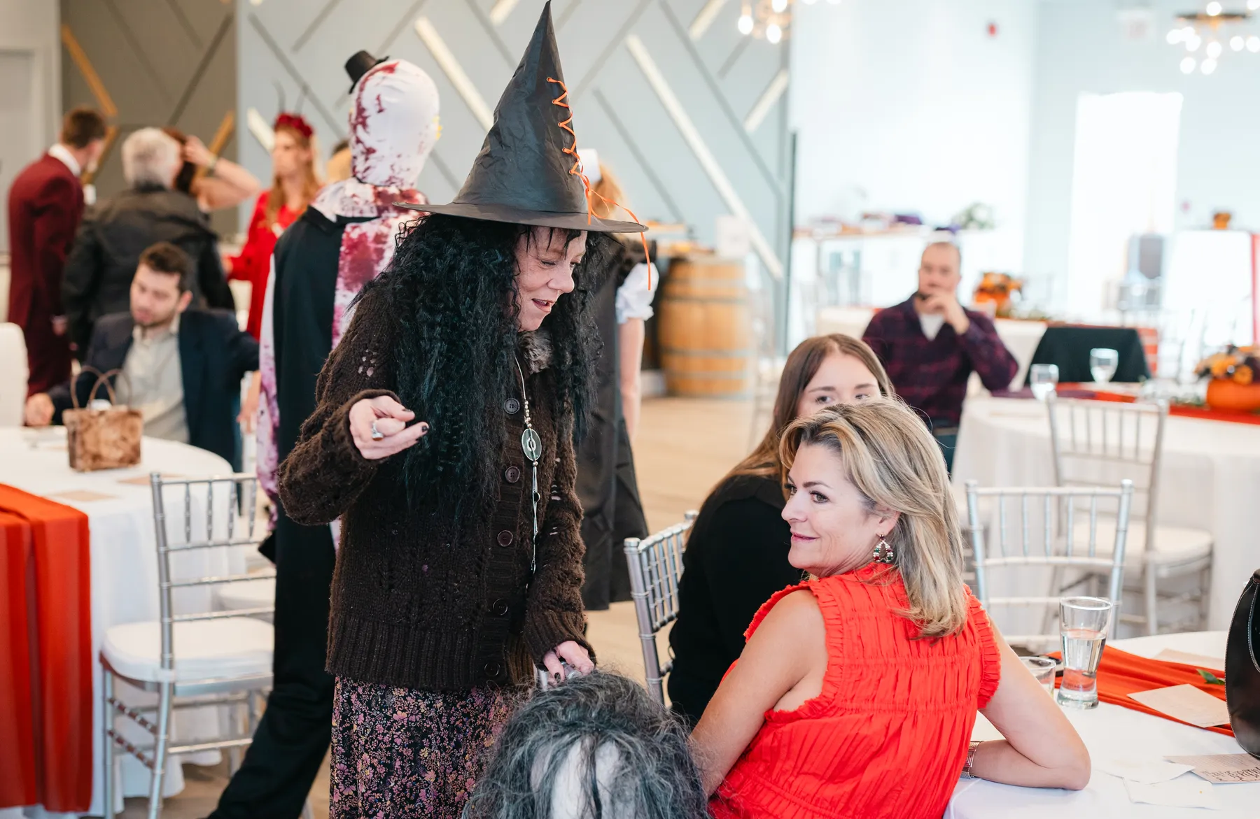 Costumed guests posing and mingling at Jenna and Jake’s Halloween party.