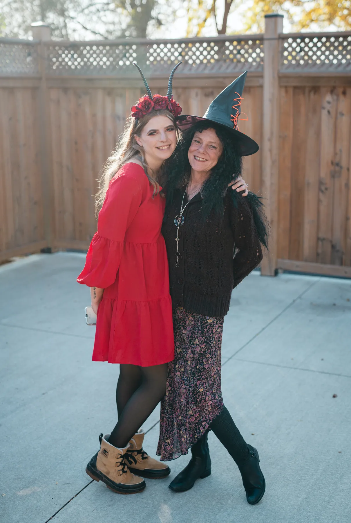 Guests walking and chatting in the outdoor courtyard at Jenna and Jake’s Halloween party.