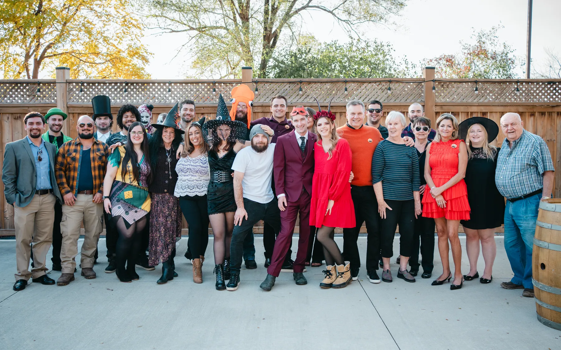 A large group of Halloween party guests posing outdoors at Jenna and Jake’s Halloween party.