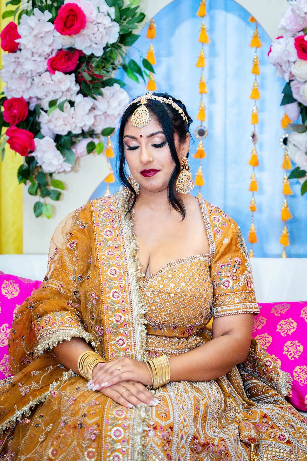 Portraits and outfit details of a woman in gold at Jessie and Erin’s Haldi celebration.