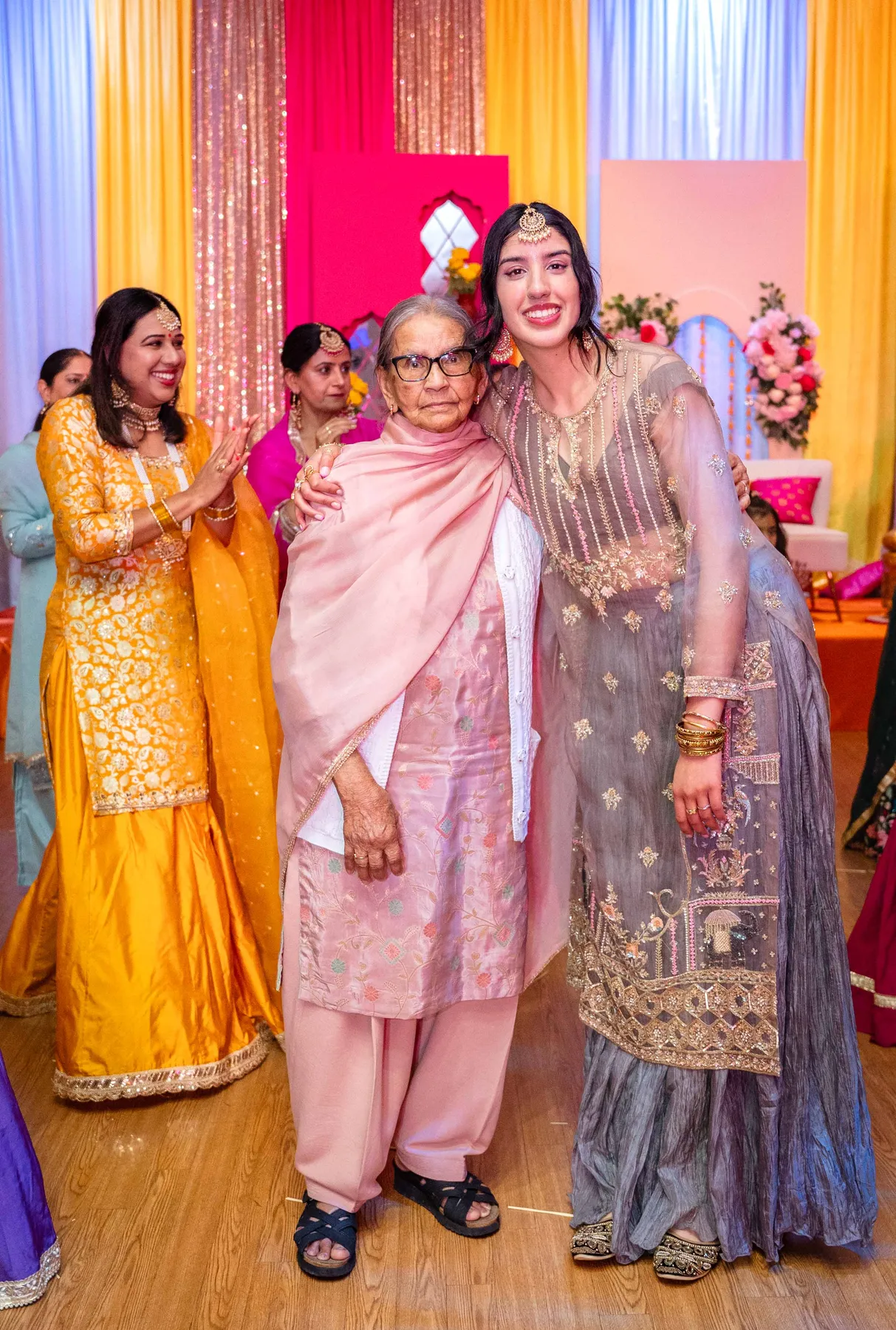 Guests posing together at Jessie and Erin’s Haldi celebration.