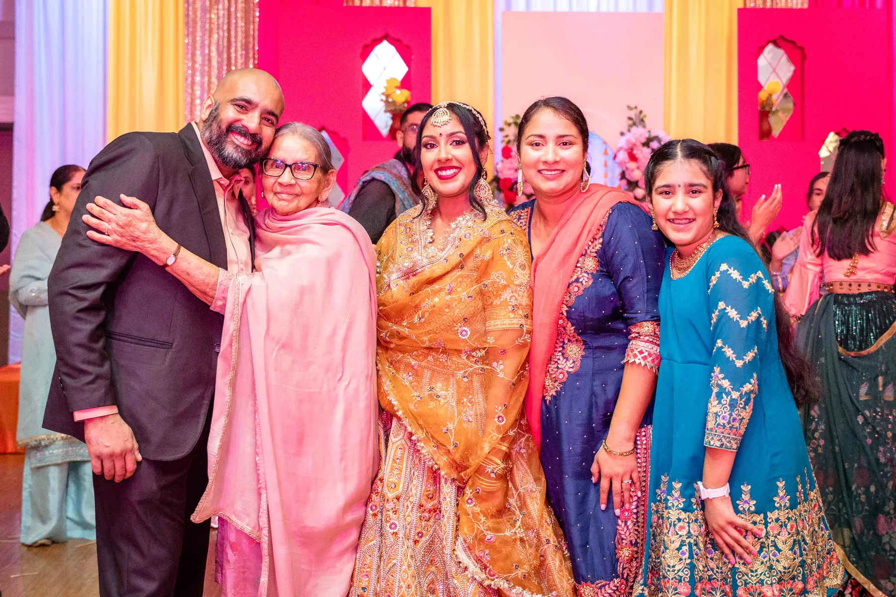 Guests posing together at Jessie and Erin’s Haldi celebration.