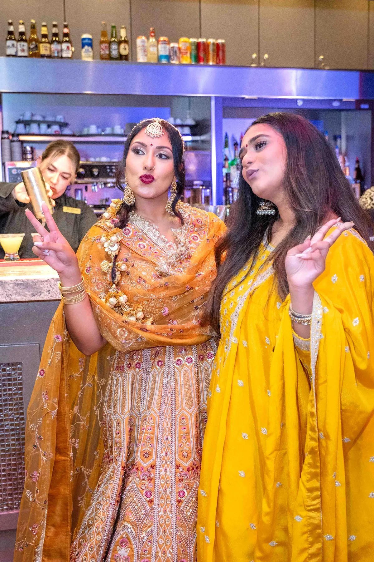 Guests gathered by the bar at Jessie and Erin’s Haldi celebration.